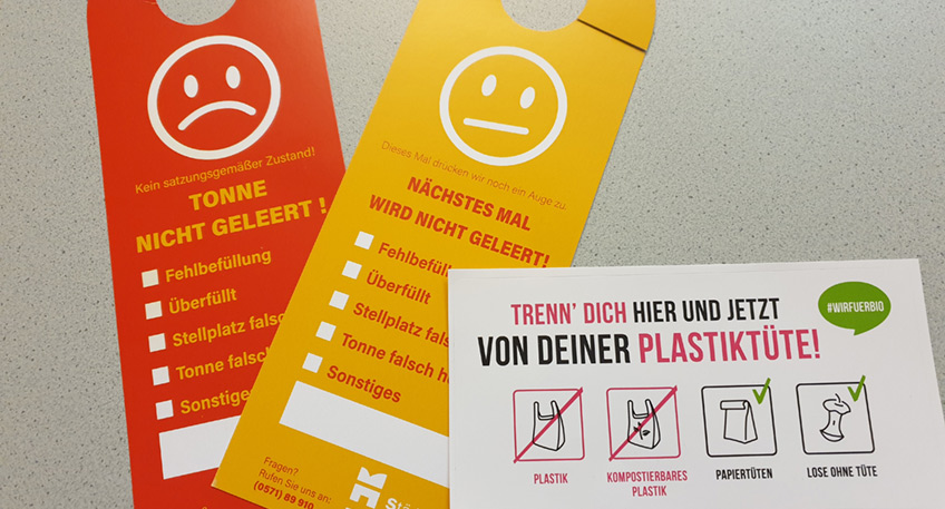 Viele Mindenerinnen und Mindener sortieren ihren Müll richtig. Damit leisten sie einen wichtigen Beitrag zum Schutz der Umwelt. „Es gibt aber leider immer noch zu viele, die den Müll nicht richtig trennen und ihre Biomülltonne falsch befüllen. Unsere Mitarbeiter*innen finden verschiedenste Störstoffe aus Kunststoff, Metall oder Glas in den Biotonnen“, so Martin Damke, der zuständige Bereichsleiter bei den Städtischen Betrieben Minden (SBM). Diese Stoffe gehören nicht in die Biotonne und führen dazu, dass zum Teil der ganze Inhalt eines Müllwagens im Kompostwerk nicht angenommen wird und als Restmüll entsorgt werden muss. Dieses Fehlverhalten Einzelner verursacht unnötige Kosten, die sich im Endeffekt in den Müllgebühren für alle widerspiegeln. Darum führen die SBM seit kurzem Kontrollen der Biomülltonnen durch und verteilen gelbe und rote Karten. Gelbe Karten werden bei einzelnen Störstoffen an die Tonnen gehängt und führen im Wiederholungsfall dazu, dass die Tonne nicht mehr geleert wird. Eine rote Karte gibt es, wenn die Tonne komplett falsch befüllt ist. Dann bleibt sie ungeleert stehen. Neben allem möglichen Restmüll werden auch kompostierbare Plastiktüten im Biomüll entsorgt. „Diese kompostierbaren Tüten gehören nicht in den Biomüll und sind ein großes Problem für uns“, sagt Damke. Die Bürger*innen kaufen in gutem Glauben kompostierbare Tüten und werfen darin ihren Müll in die Biotonne. Die kompostierbaren Tüten sind aber von den anderen nicht zu unterscheiden. Außerdem verrotten sie im Kompostwerk zu langsam. Im Kompost, der eigentlich aus dem Biomüll entsteht, ist als Folge davon so viel Plastik, dass er nicht verwendet werden kann. Entgegen der Angaben der Hersteller dürfen Plastiktüten nicht in den Biomüll gelangen. Lassen Sie sich nicht durch die Angabe „kompostierbare Plastiktüten“ in die Irre führen, sondern verwenden sie Papiertüten oder Zeitungspapier für die Sammlung des Biomülls, hebt Martin Damke hervor. Die SBM beteiligen sich bereits seit 2018 an der deutschlandweiten Kampagne #wirfürbio, werben mit Aufklebern und Informationen für eine bessere Mülltrennung. Jetzt folgt als nächste Stufe die Kontrolle der Biotonnen durch die SBM-Mitarbeiter. „Finden wir dabei Stoffe, die nicht in die Biotonne gehören, so gibt es eine gelbe oder rote Karte. Bei einer roten Karte bleibt die Biotonne ungeleert stehen“, so die Ankündigung vom Bereichsleiter. Das wird so lange gemacht, bis die Nutzenden den Müll nachsortiert haben. Ist die Biotonne ordnungsgemäß befüllt, wird sie dann bei der nächsten Leerung wieder mit geleert. Daher der abschließende Appell der SBM: „Finden Sie eine gelbe oder rote Karte an Ihrer Biotonne, überprüfen Sie bitte Ihre Sortierung und rufen auch gerne bei uns an. Nur gemeinsam können wir durch die richtige Mülltrennung die anschließende Verwertung gewährleisten und so einen wichtigen Anteil zum Klima- und Umweltschutz beitragen“, unterstreicht Damke. Hintergrund: Die Städtischen Betriebe leeren alle zwei Wochen rund 22.000 Biotonnen, dazu kommen noch die Großbehälter von den Wohnanlagen und Gewerbebetrieben. Das ist eine große Menge Biomüll, der von den Müllfahrzeugen anschließend zur Pohlschen Heide zum Kompostwerk gebracht wird. Seit längerer Zeit fallen dabei immer wieder und vermehrt Störstoffe auf, die nicht in den Biomüll gehören. Das ist ein Problem, da der Müll im Kompostwerk nicht als Biomüll angenommen wird und teuer als Restmüll entsorgt werden muss. Das führt dazu, dass dieser Müll aus dem Verwertungskreislauf herausfällt und nicht zu Kompost verarbeitet werden kann.